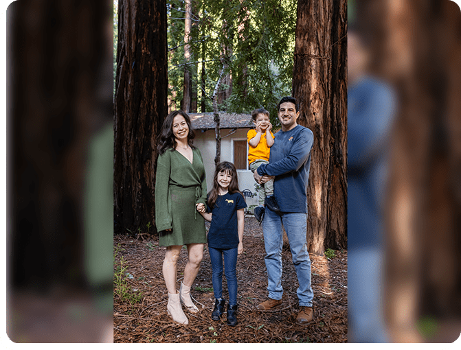 A family posing for a picture in the woods.